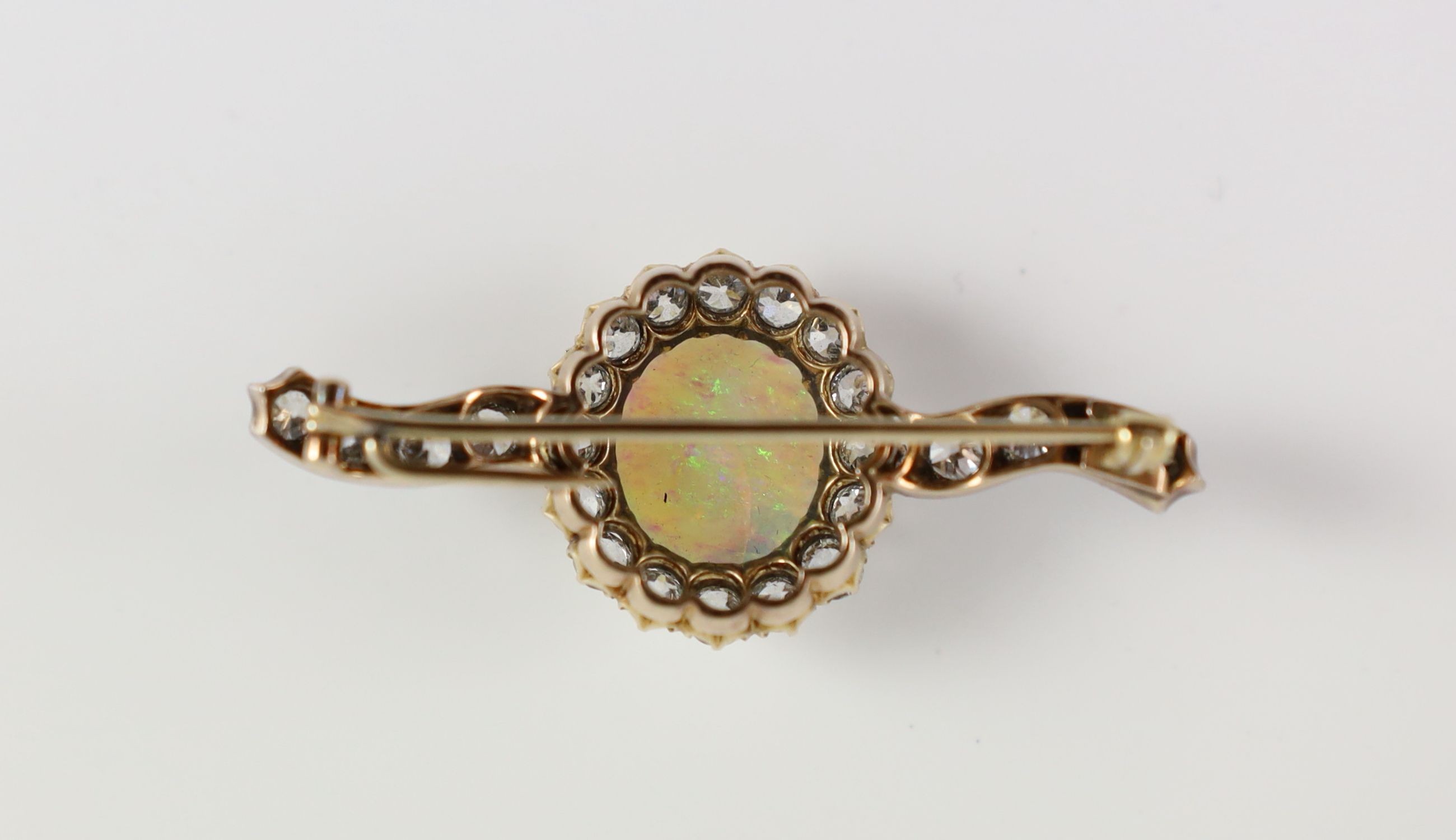 An early 20th century gold, white opal and diamond cluster set brooch